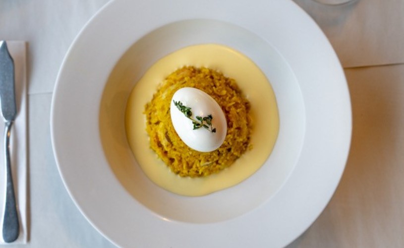 Fishers kedgeree and lemon butter sauce served in a white dish